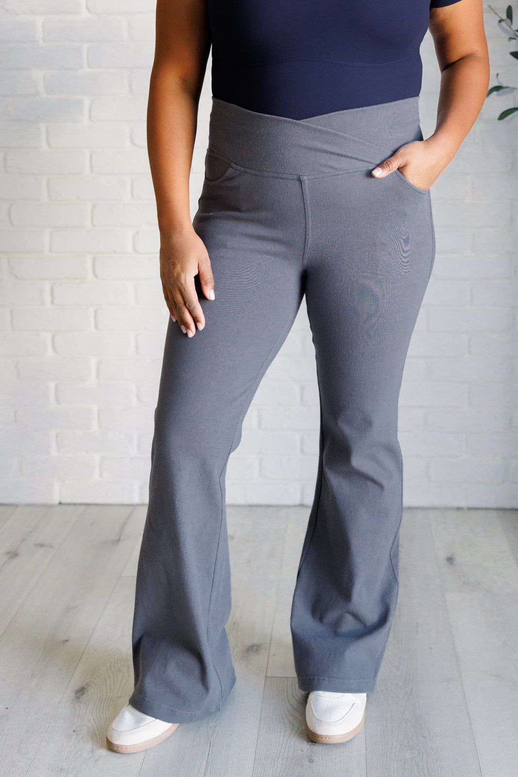 Twill Flared Crossover Waist Pants in Titanium with a high V-waistline, medium-stretch fabric, flared legs, and functional front and back pockets.