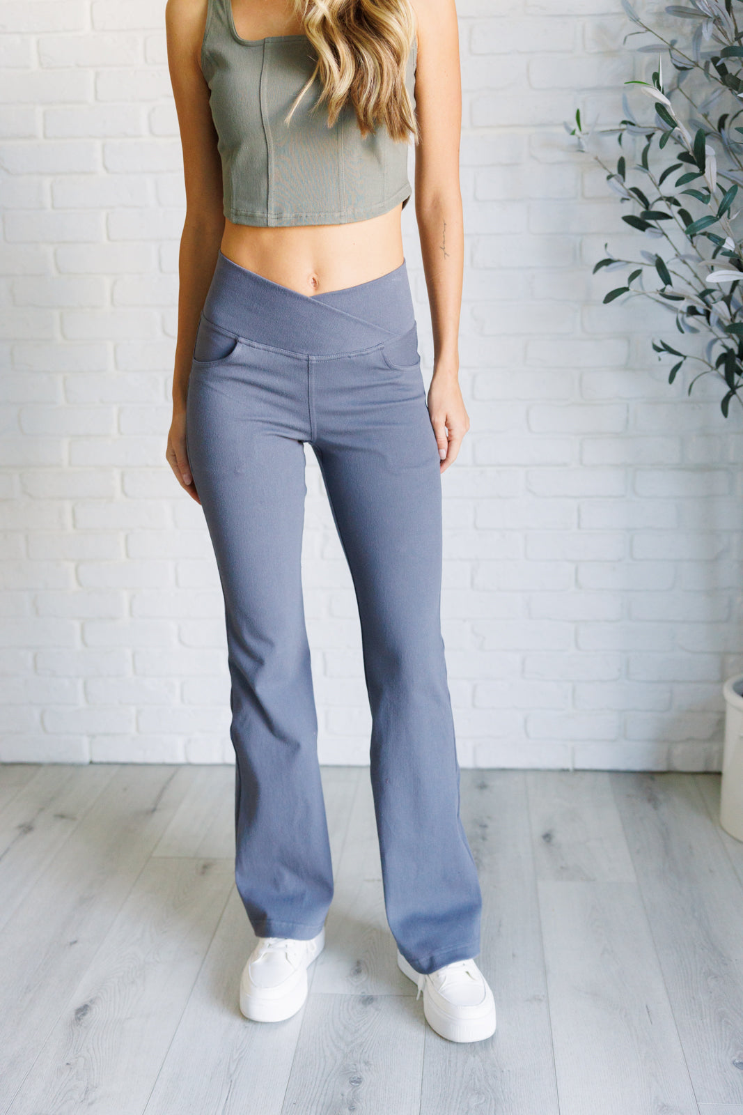 Twill Flared Crossover Waist Pants in Titanium with a high V-waistline, medium-stretch fabric, flared legs, and functional front and back pockets.