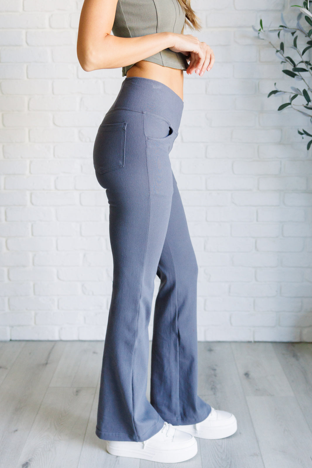 Twill Flared Crossover Waist Pants in Titanium with a high V-waistline, medium-stretch fabric, flared legs, and functional front and back pockets.