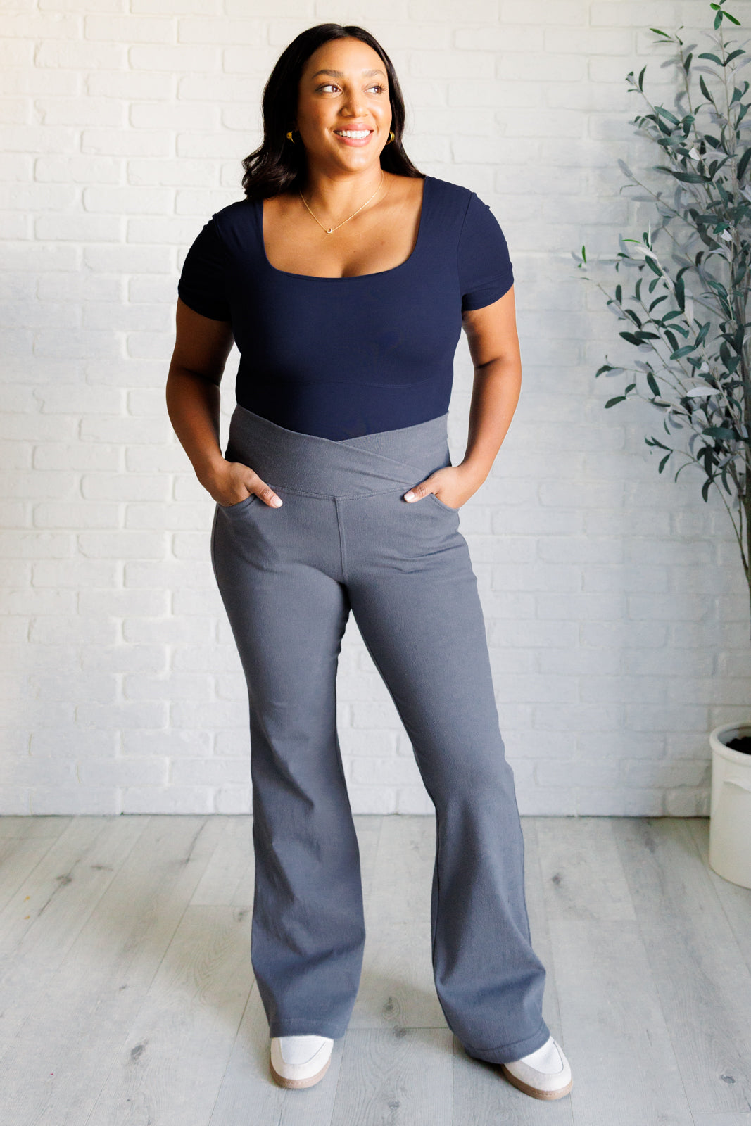 Twill Flared Crossover Waist Pants in Titanium with a high V-waistline, medium-stretch fabric, flared legs, and functional front and back pockets.