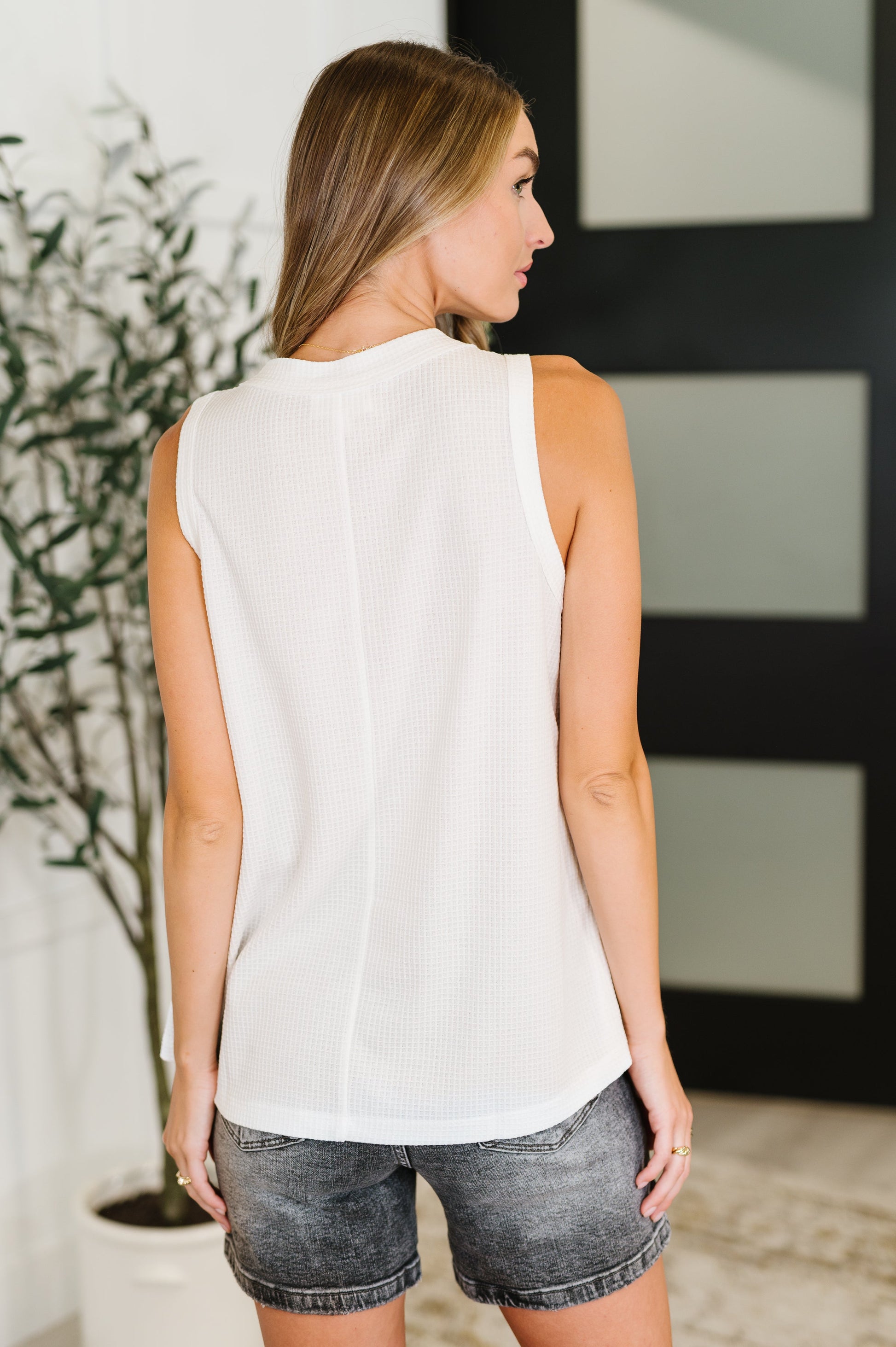Back view of the Alani Sleeveless Top in ivory, showcasing the slightly sheer waffle knit fabric and relaxed fit.