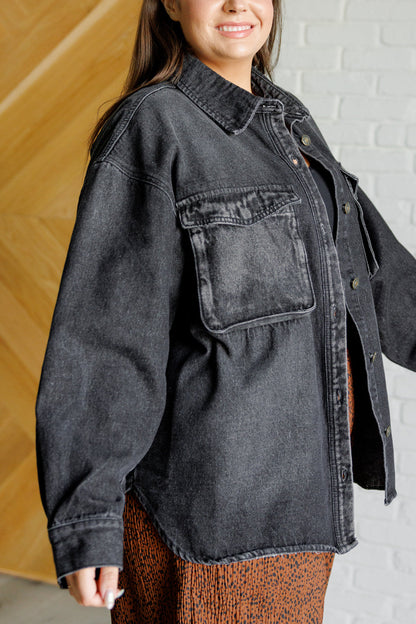 Plus-size model side angle of Fia denim shacket showing oversized silhouette and snap pocket detail.