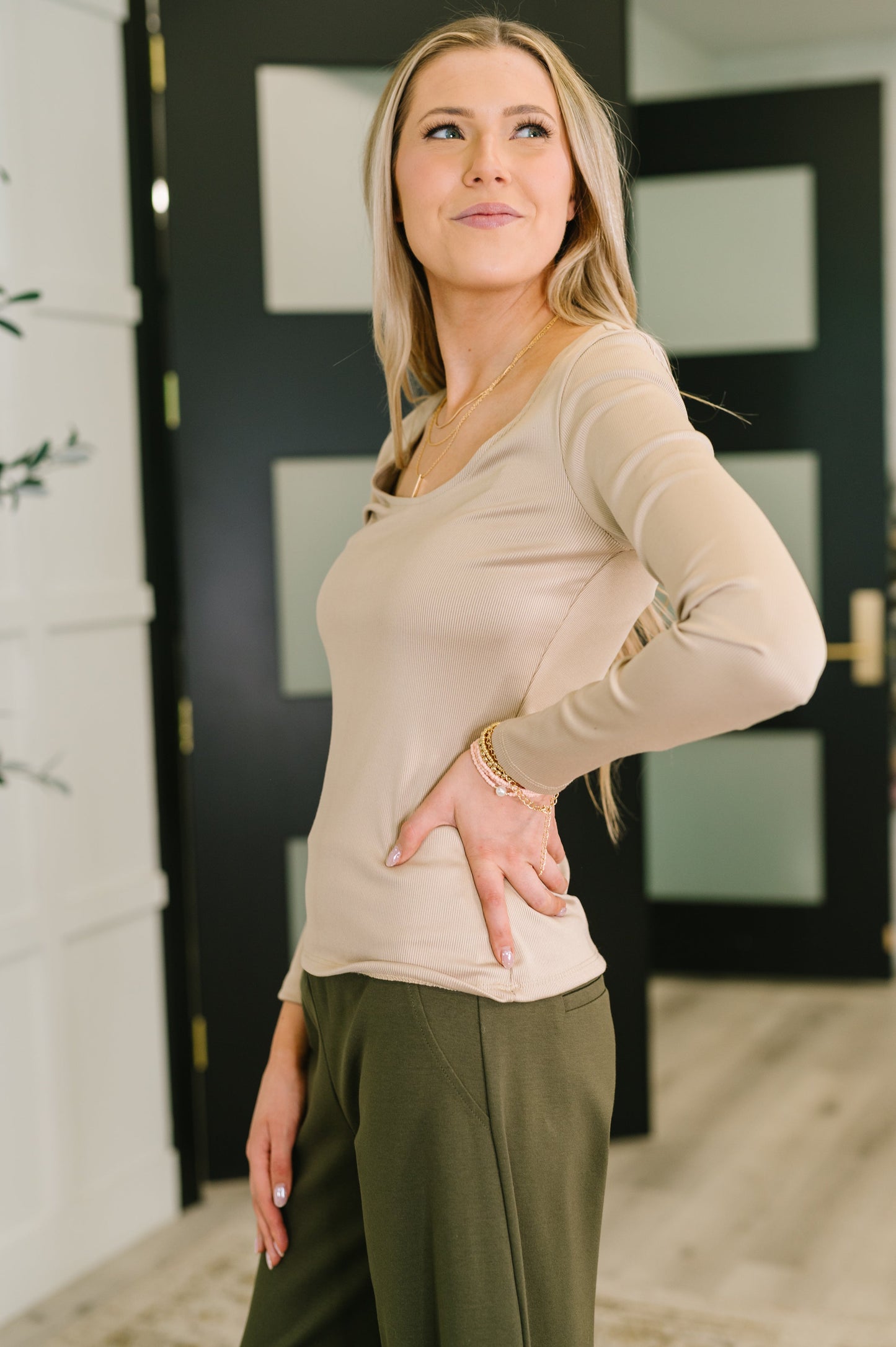 Side angle of Laura Basic Long Sleeve Top in Sand showing slim fit silhouette.