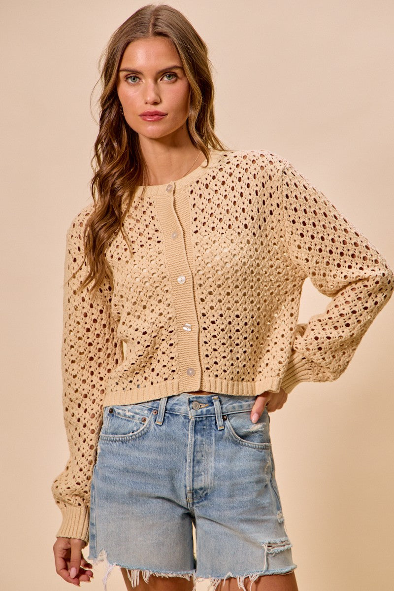 Model wearing Casey Open Knitted Button Down Cardigan in natural with lightweight open knit design.