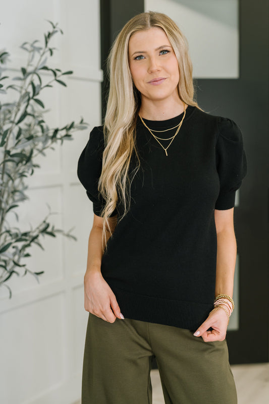 Giselle Puff Sleeve Blouse in Black, front view showing ribbed knit and banded crew neckline.