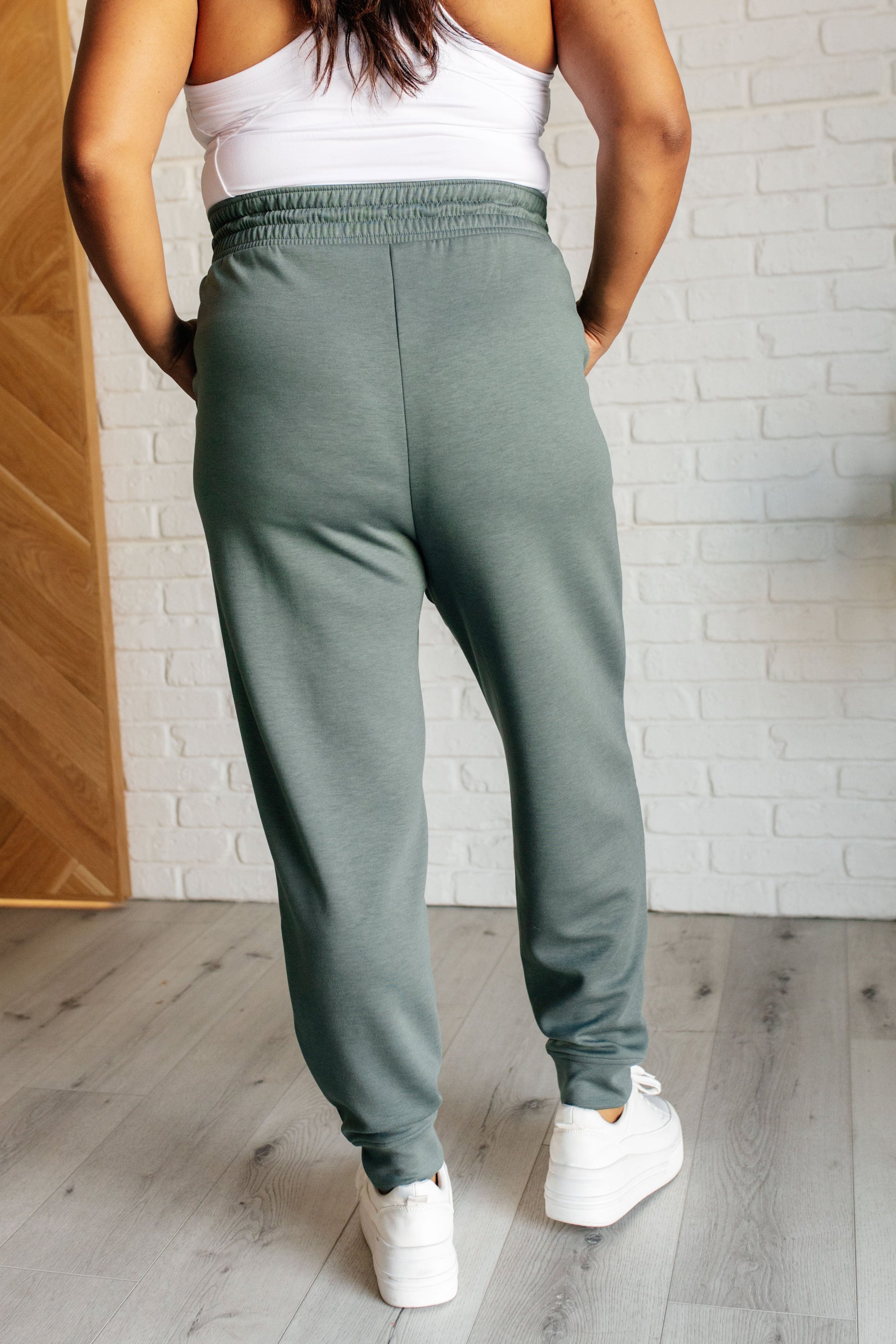 Center Seam Scuba Joggers in ash jade featuring a front seam, elastic waistline with functional drawstring, side pockets, and banded hem for a comfortable and stylish fit.