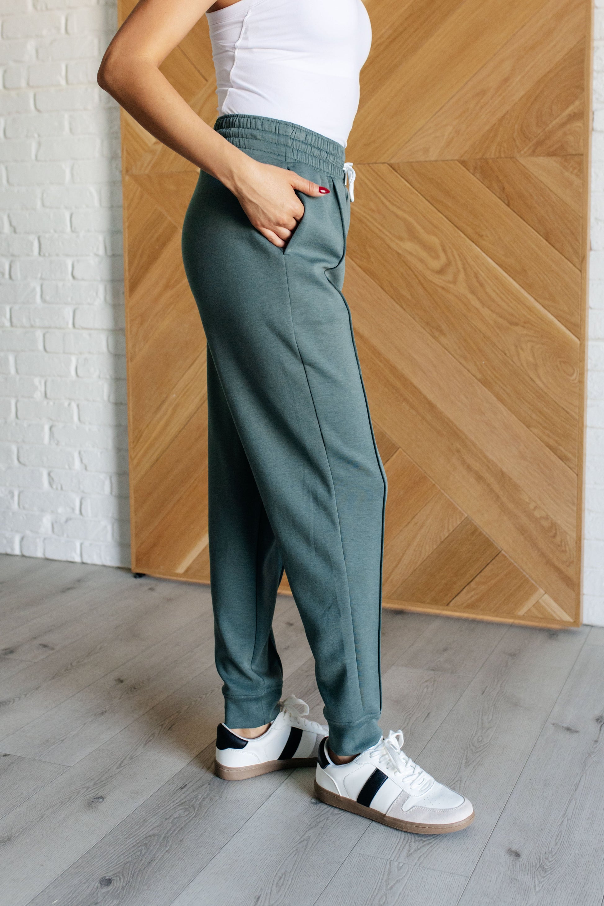 Center Seam Scuba Joggers in ash jade featuring a front seam, elastic waistline with functional drawstring, side pockets, and banded hem for a comfortable and stylish fit.