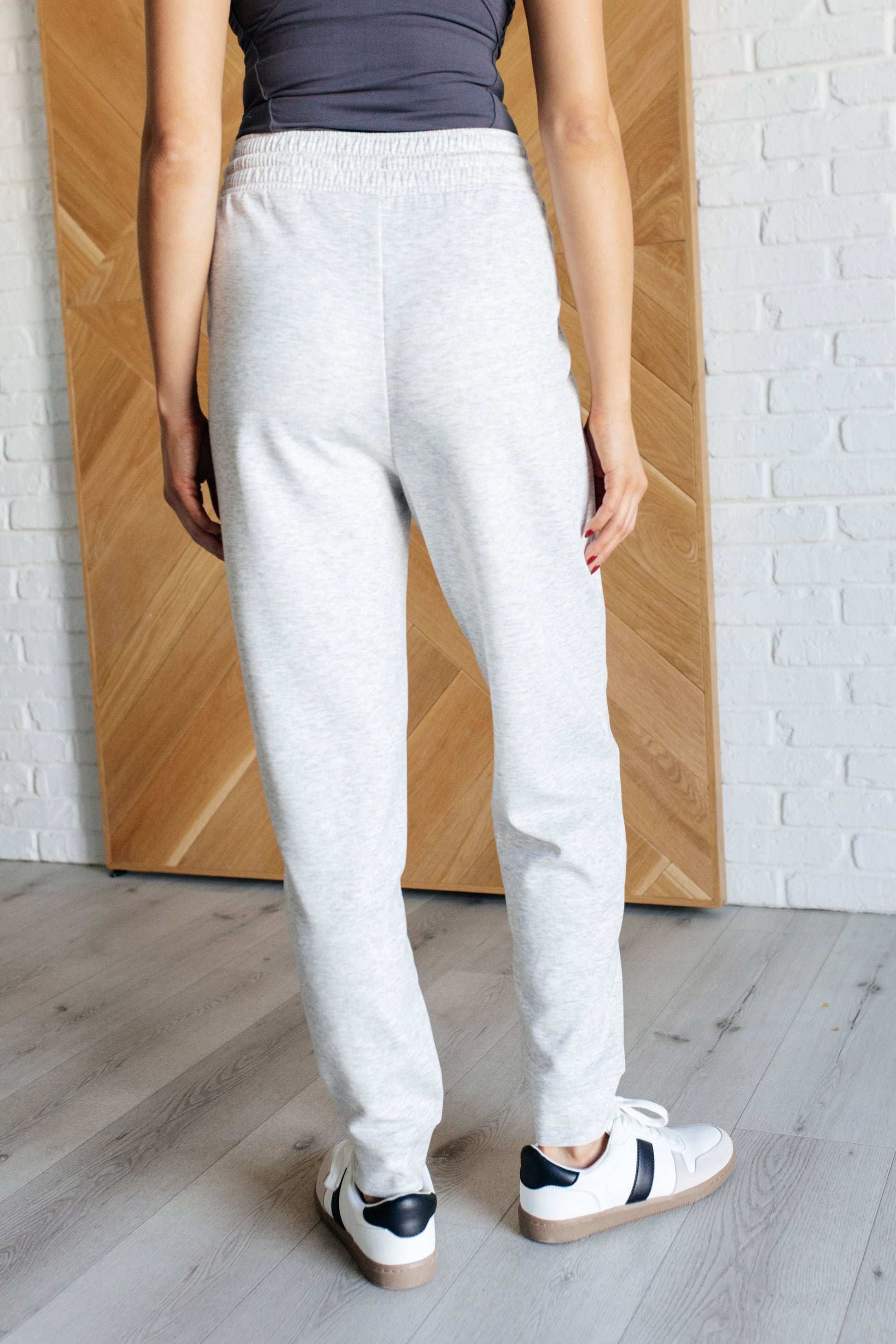 Center Seam Scuba Joggers in heather gray featuring a front seam, elastic waistline with functional drawstring, side pockets, and banded hem for a comfortable and stylish fit.