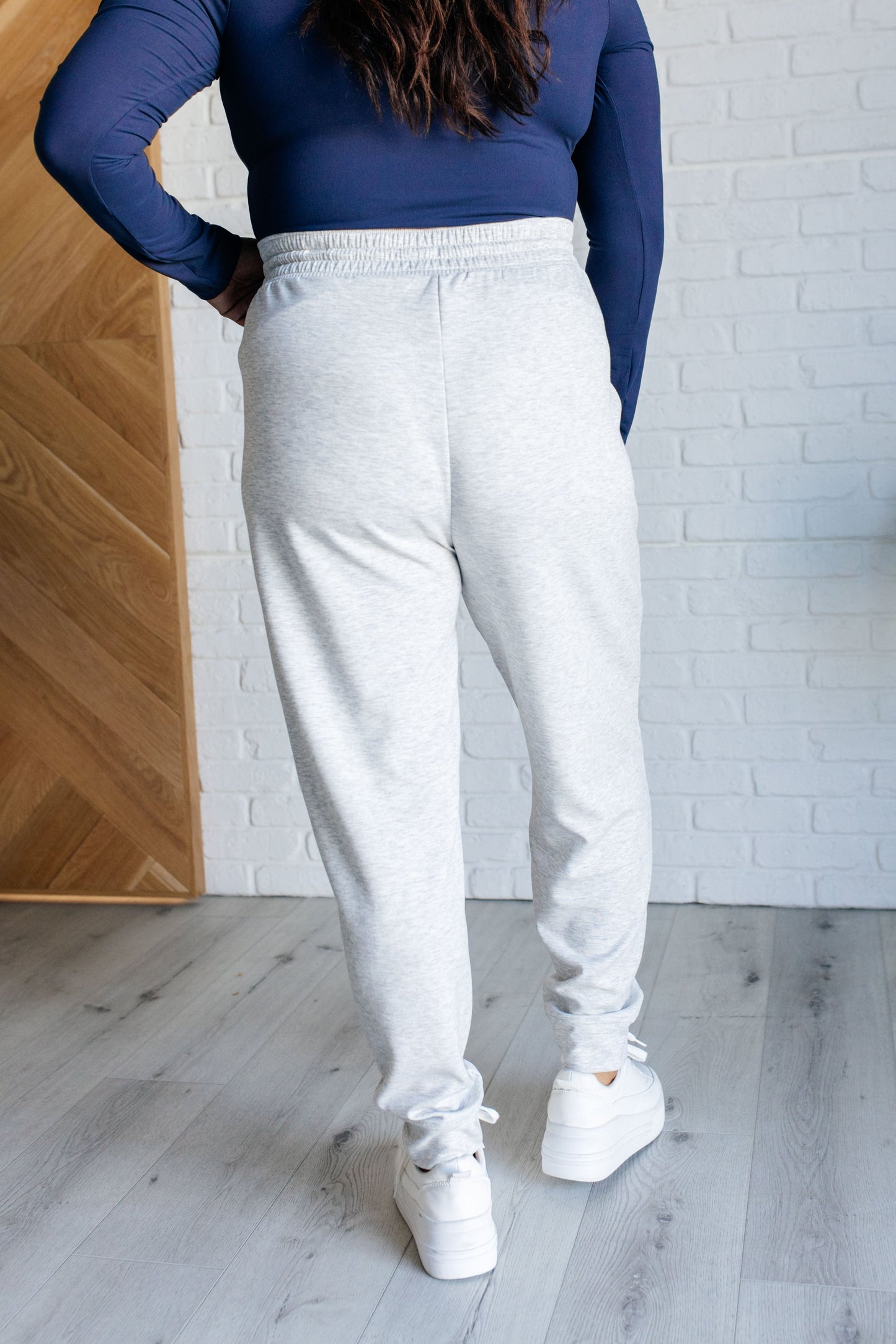 Center Seam Scuba Joggers in heather gray featuring a front seam, elastic waistline with functional drawstring, side pockets, and banded hem for a comfortable and stylish fit.