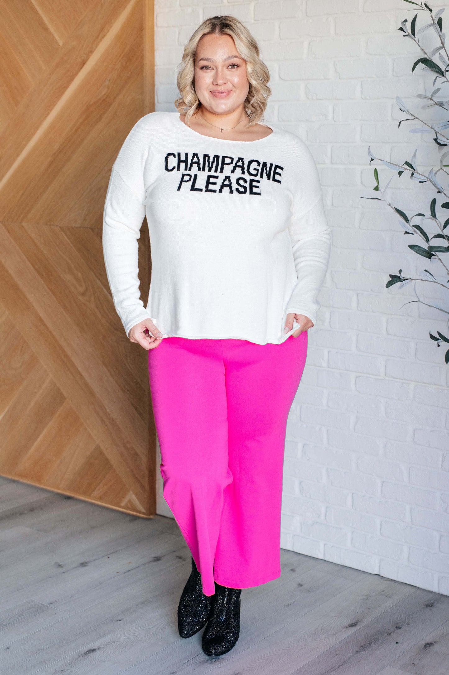 Women's white lightweight sweater with the text "Champagne Please" on the front, featuring a boat neck, long drop-shoulder sleeves, and a side slit.