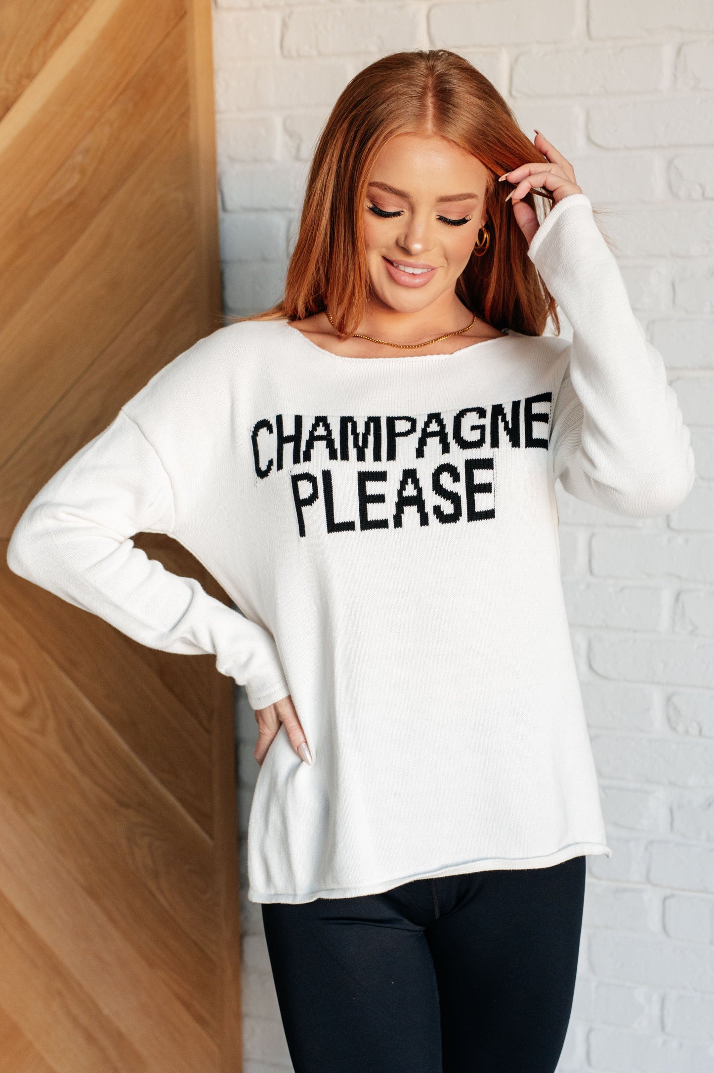 Women's white lightweight sweater with the text "Champagne Please" on the front, featuring a boat neck, long drop-shoulder sleeves, and a side slit.