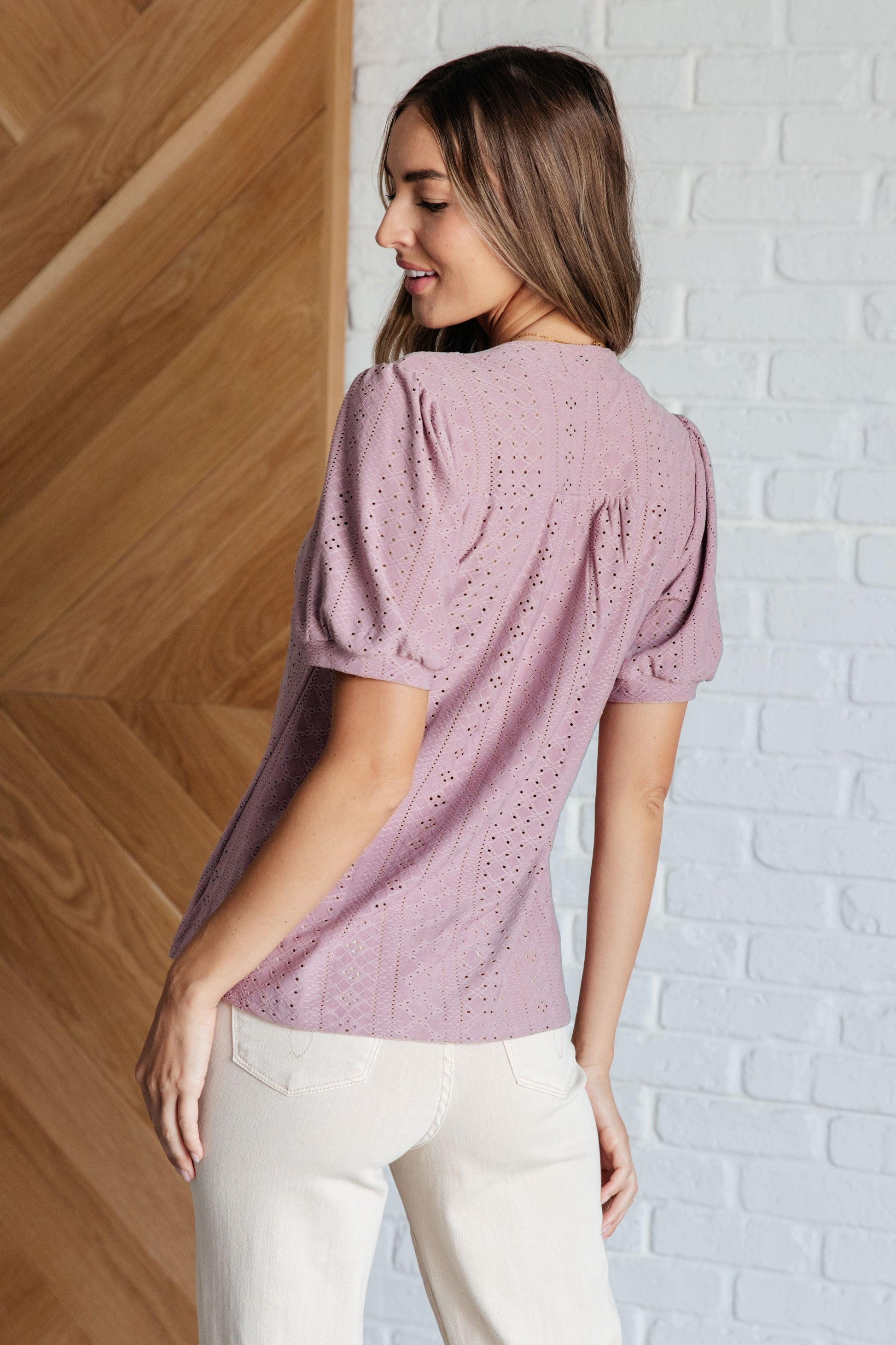 Back view of light mauve knit eyelet Chance Pleat Front Blouse with pleated front detail.