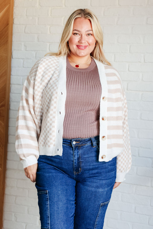 Women's cardigan in white and beige with a check and stripe pattern.  ribbed knit trim, drop shoulders, long sleeves, and a button-front closure. Made from midweight sweater knit with a V-neckline.