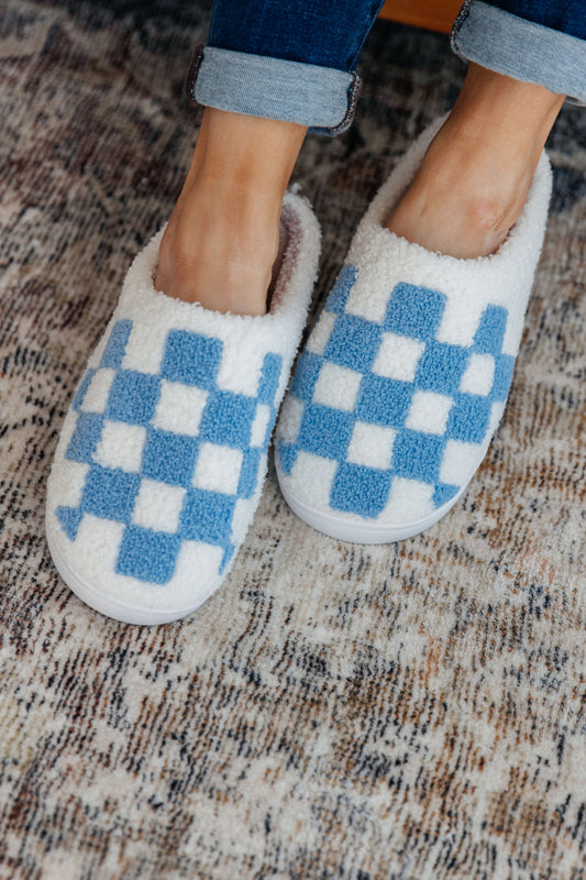 Blue and white checkered print slippers with a plush French terry upper, cushioned insole, and rubber sole.