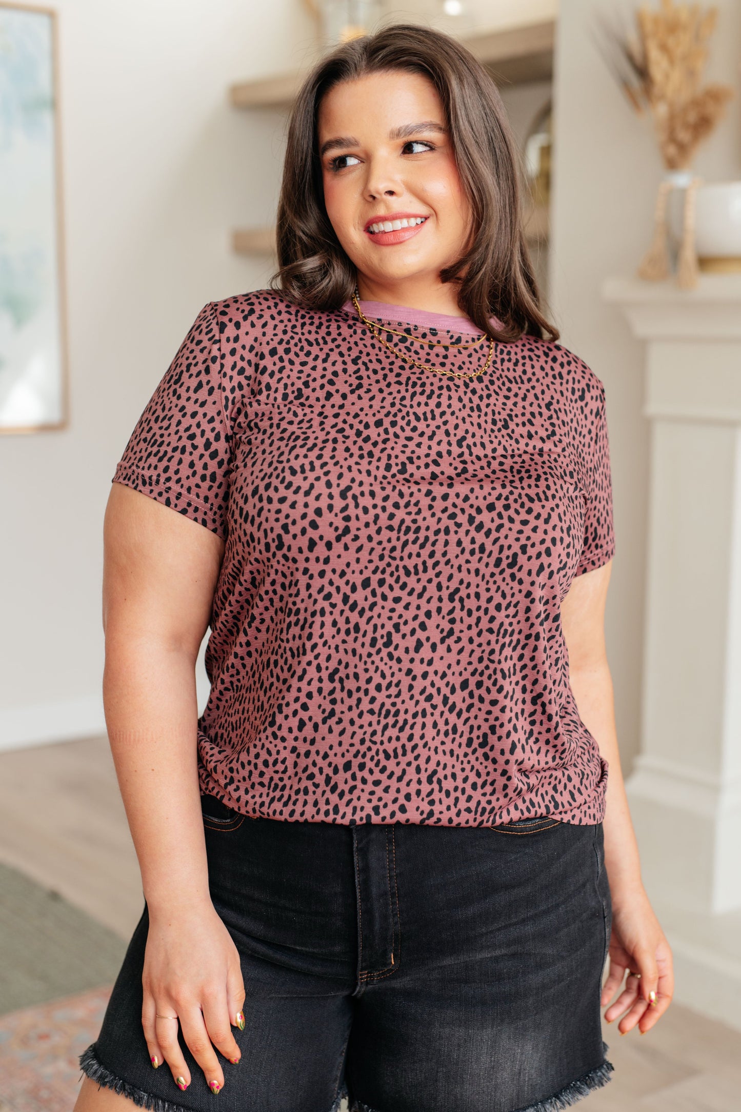 Pink women's top with cheetah print, featuring a crew neckline, short sleeves, and contrasting pink trim, made from lightweight Bulgari knit fabric.