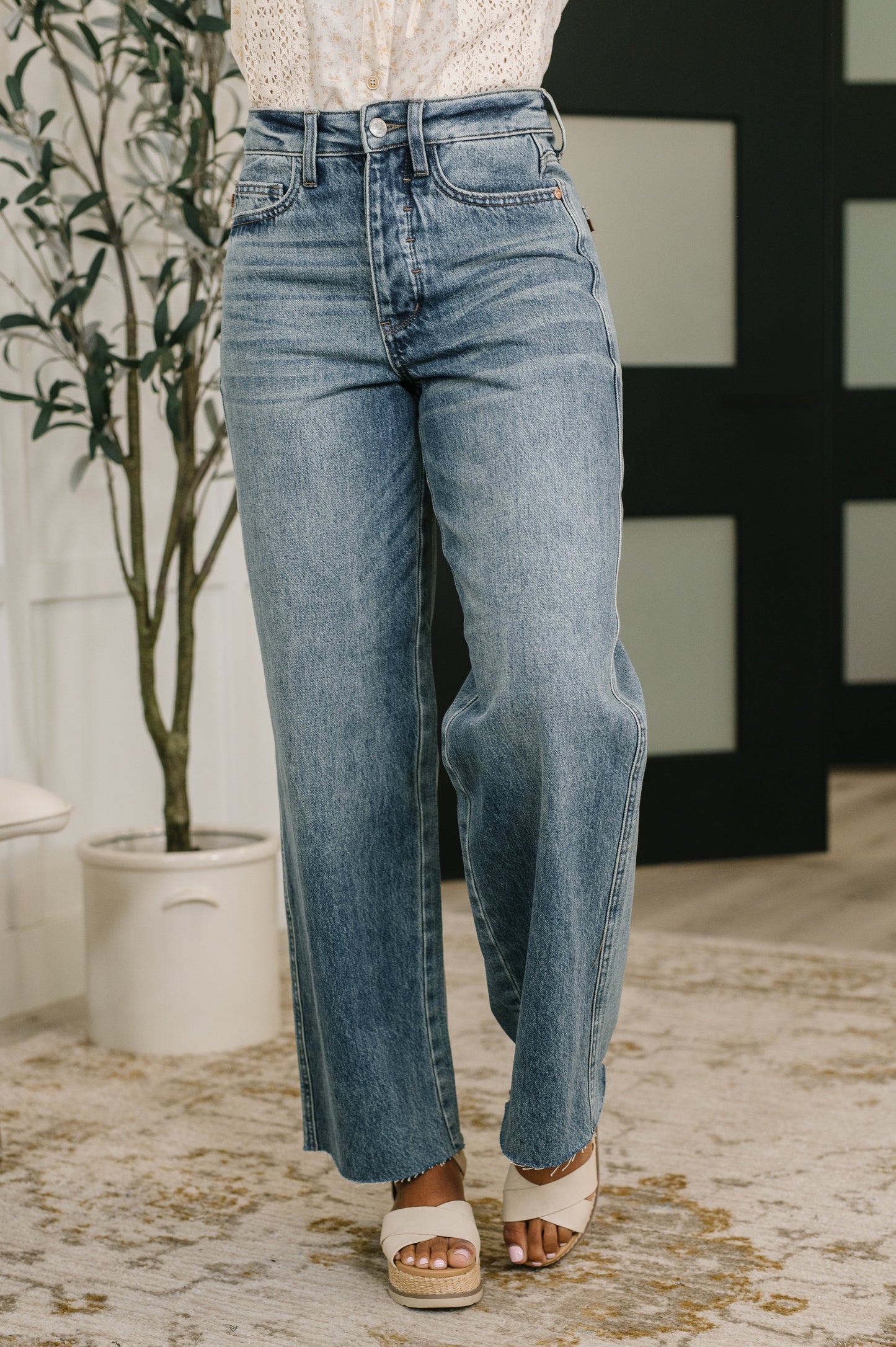 Model wearing Ciera High Waist Rigid Magic Wilhelmina Baggy Jeans by Judy Blue light wash denim.
