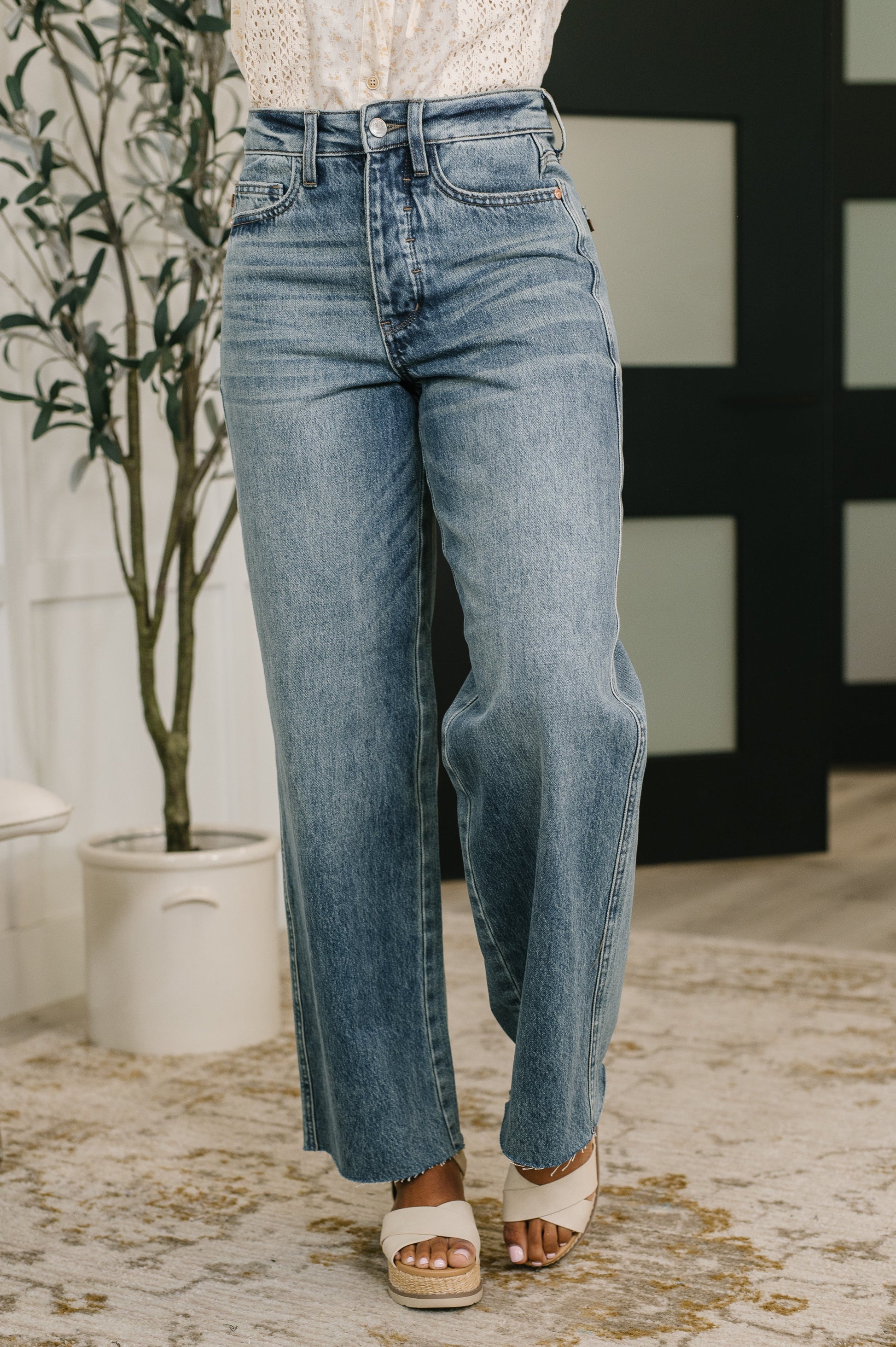 Model wearing Ciera High Waist Rigid Magic Wilhelmina Baggy Jeans by Judy Blue light wash denim.