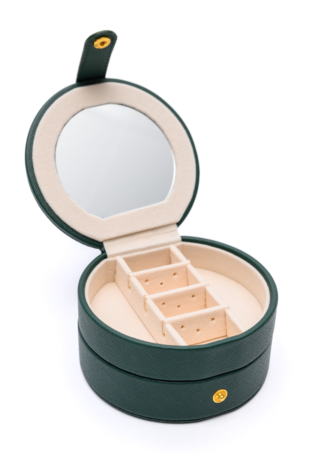 Circular Travel Jewelry Case in Green, with secure snap closure, small mirror, six ring slots, four perforated sections for earrings, six compartments for jewelry, and three necklace hooks.