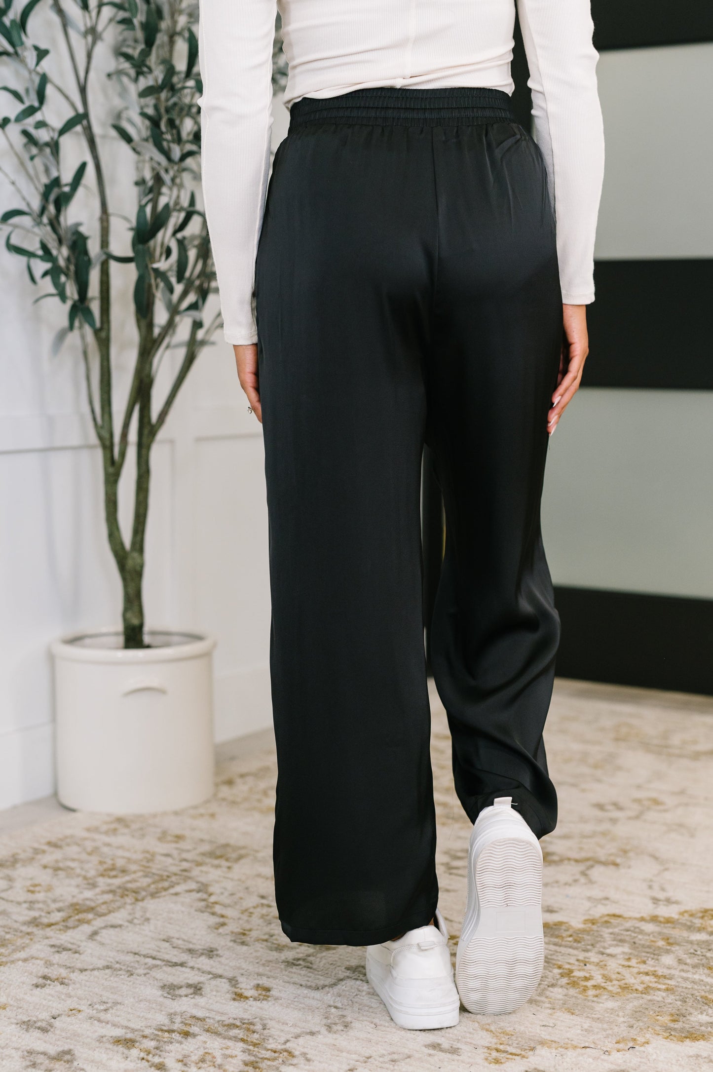 Back view of Cita Wide Leg Bottoms in Black featuring smooth wide leg and flattering drape.