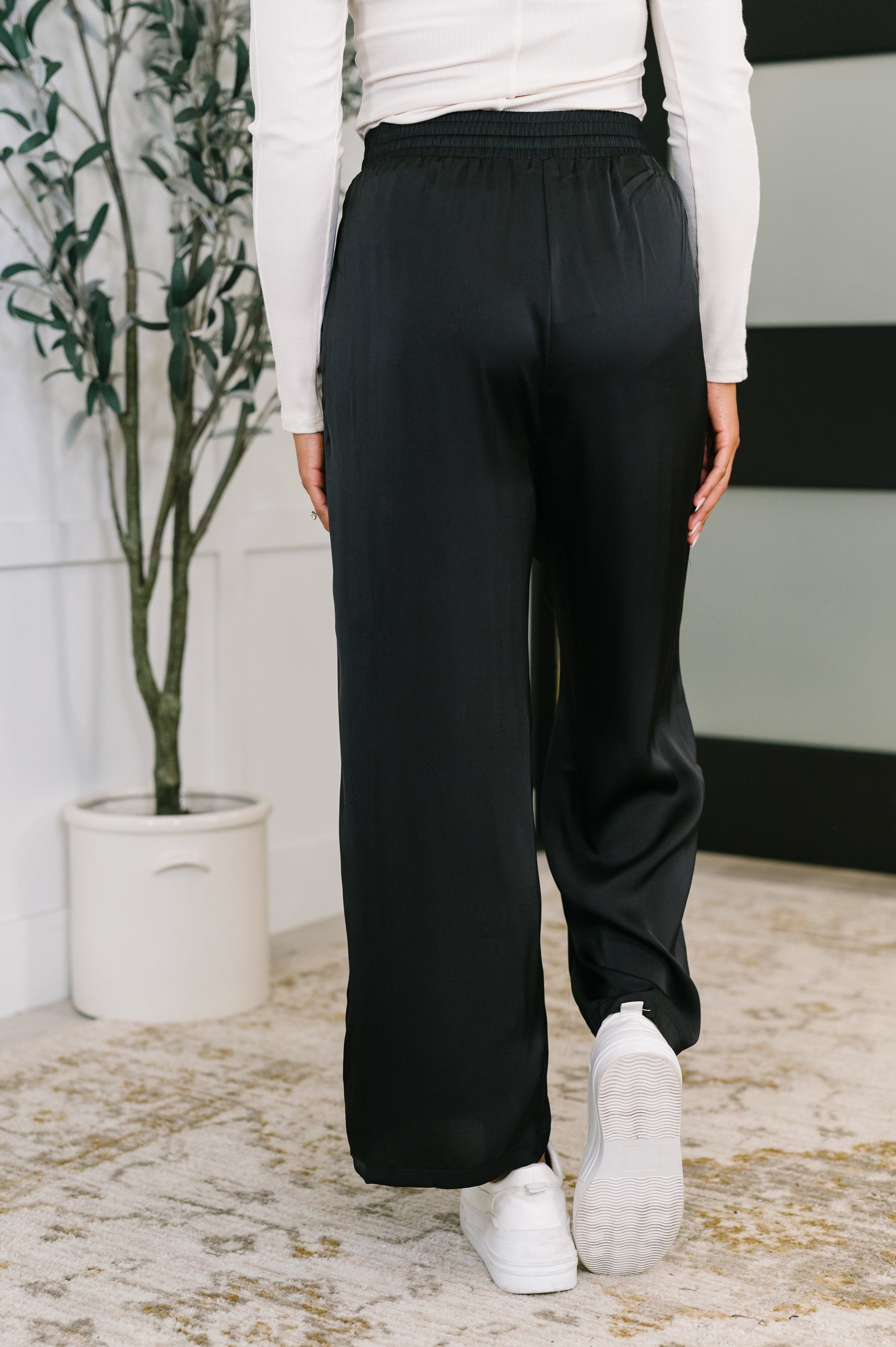 Back view of Cita Wide Leg Bottoms in Black featuring smooth wide leg and flattering drape.