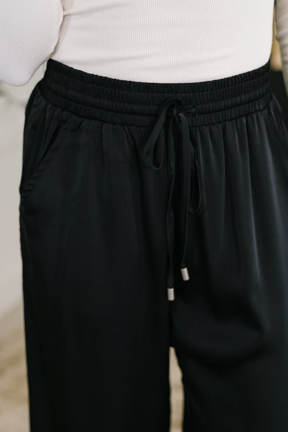 Close-up of Cita Wide Leg Bottoms waistband with adjustable drawstring and satin texture.