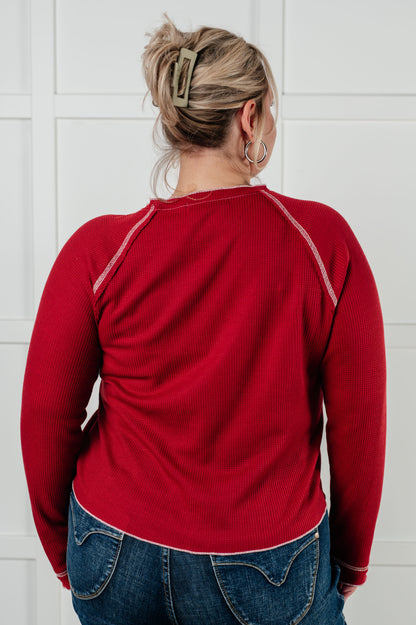 Back view of plus size model in Pavla Waffle Knit Top, red waffle knit with raw edge hem