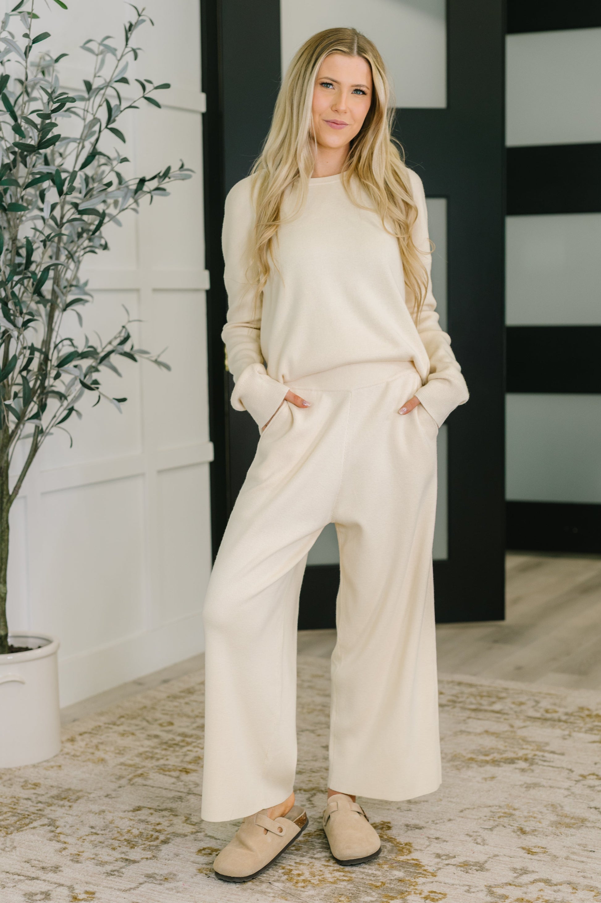 Full body view of model wearing Clove Culottes in Oat with matching Clove Sweater