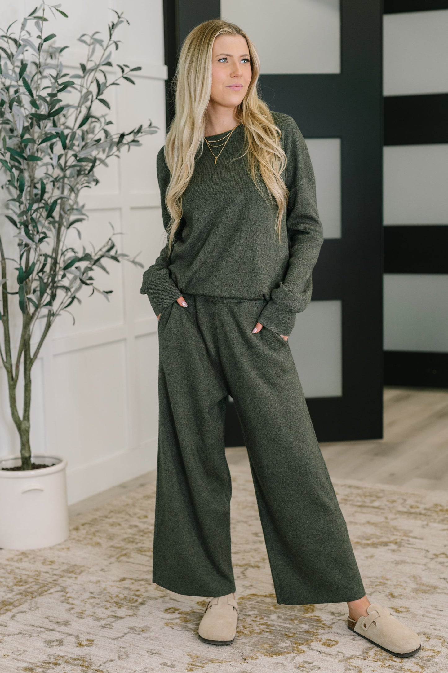 Full body view of model wearing Clove Sweater in Moss with matching culottes