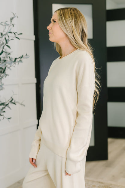 Side view of Clove Sweater in Oat showing drop shoulders and long sleeves