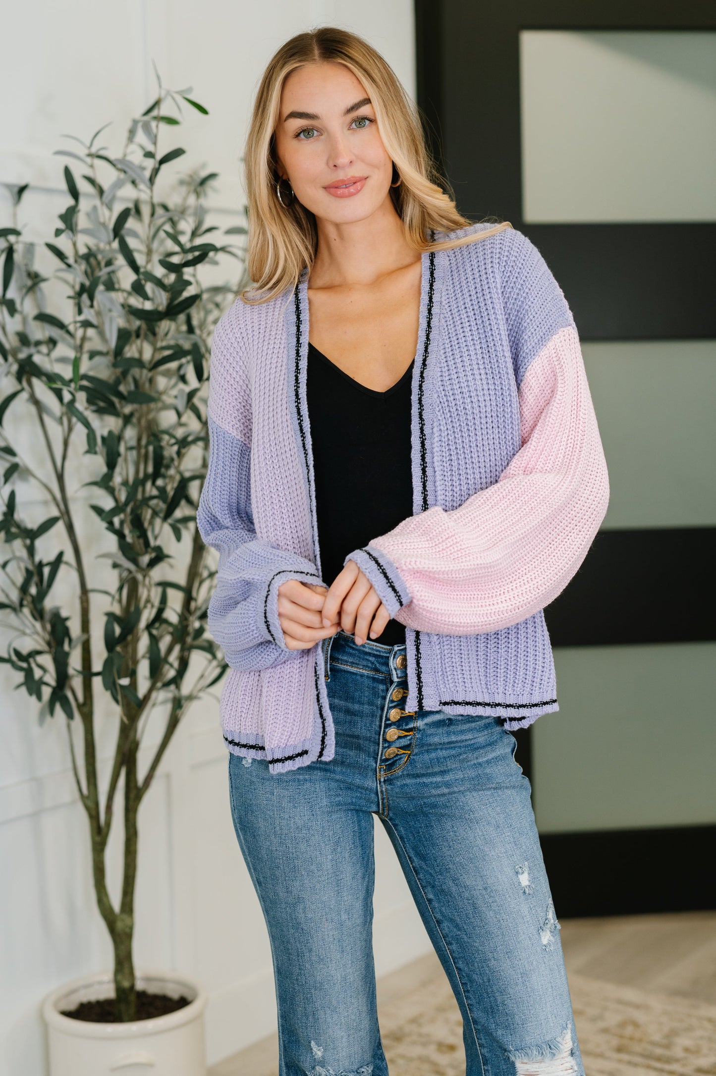 Model wearing Coraline Color Block Cardigan in periwinkle multi with open front and drop shoulders.