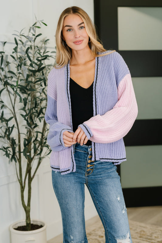 Model wearing Coraline Color Block Cardigan in periwinkle multi with open front and drop shoulders.