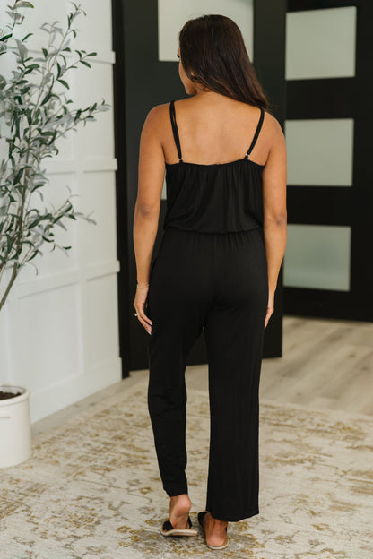 Back view of Viola Jumpsuit in Black with surplice straps and elastic waist