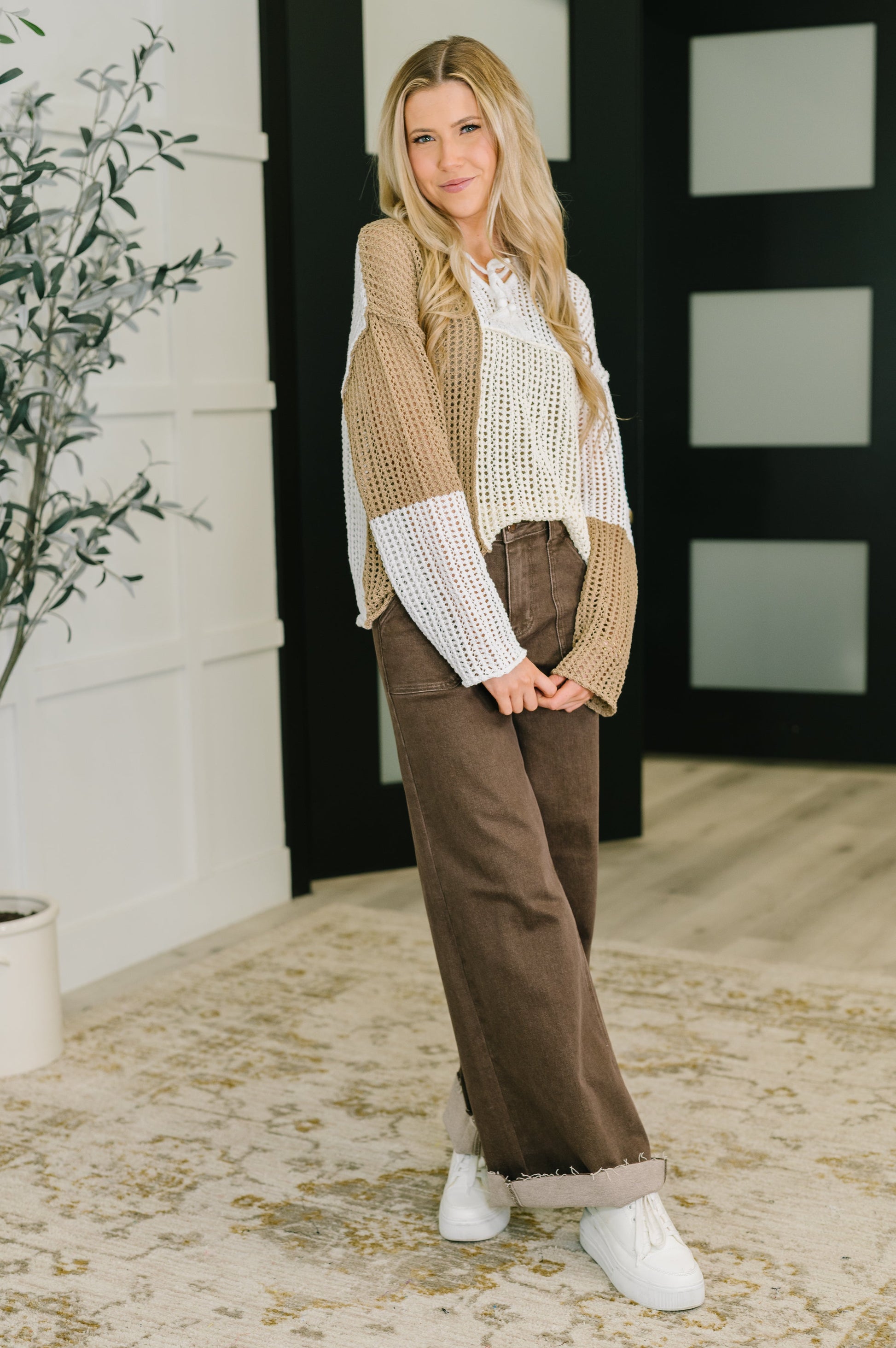 Model wearing Danielle Loose Knit Sweater styled with wide-leg pants and sneakers.