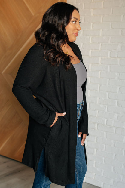 Side angle of plus size Cova Cozy Cardigan highlighting side slits and ribbed knit.