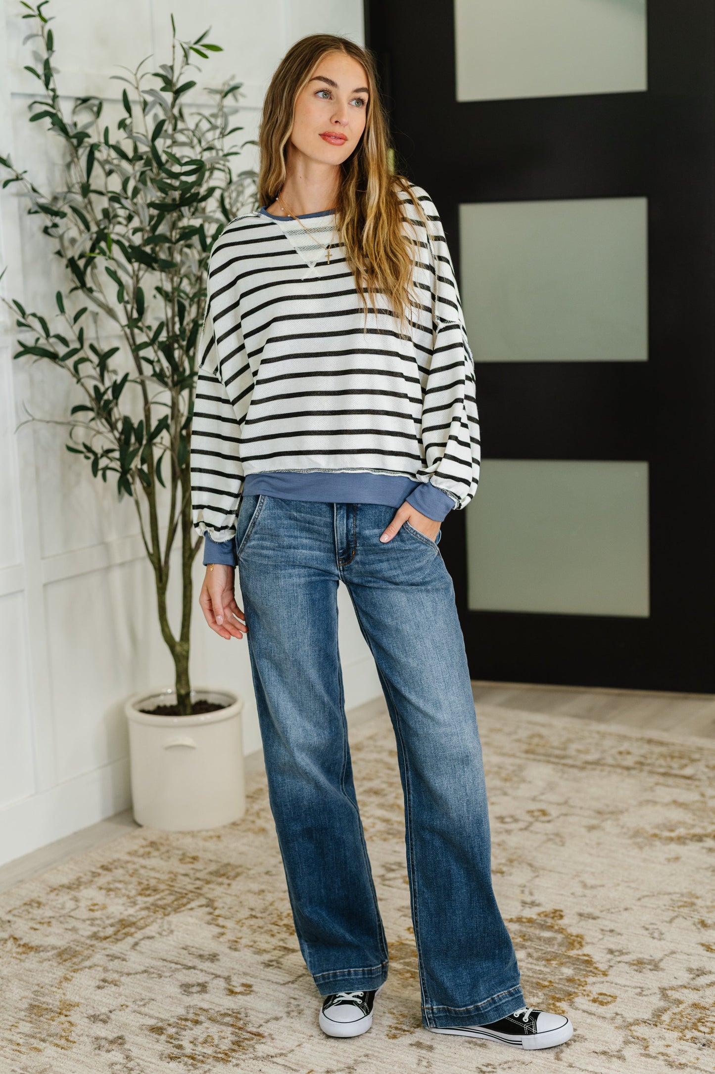 Size inclusive relaxed fit drop shoulder striped pullover in black, white, and denim.
