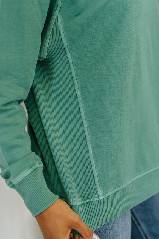 Close-up of Nicia Dark Green Mineral Wash Pullover, ribbed neckline and textured French terry fabric