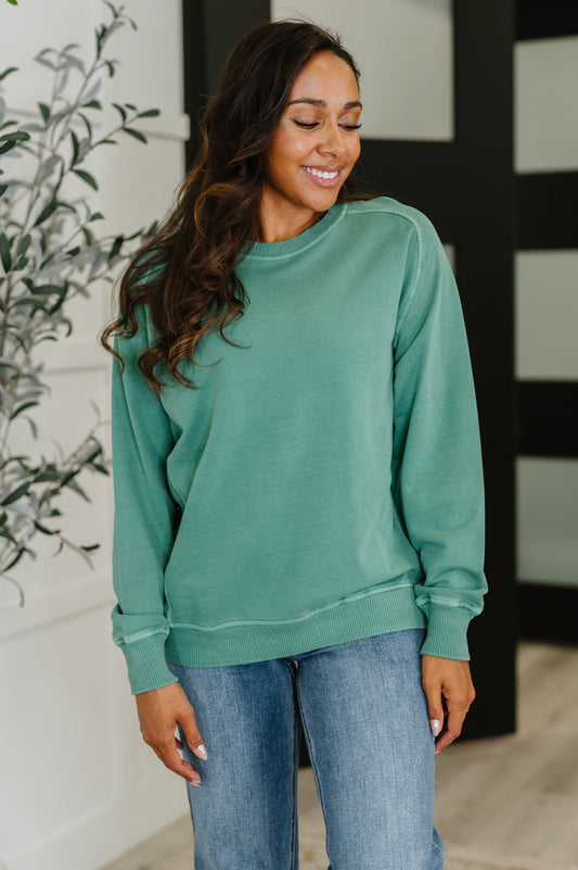 Model wearing Nicia Dark Green Mineral Wash Pullover, ribbed neckline and raglan sleeves