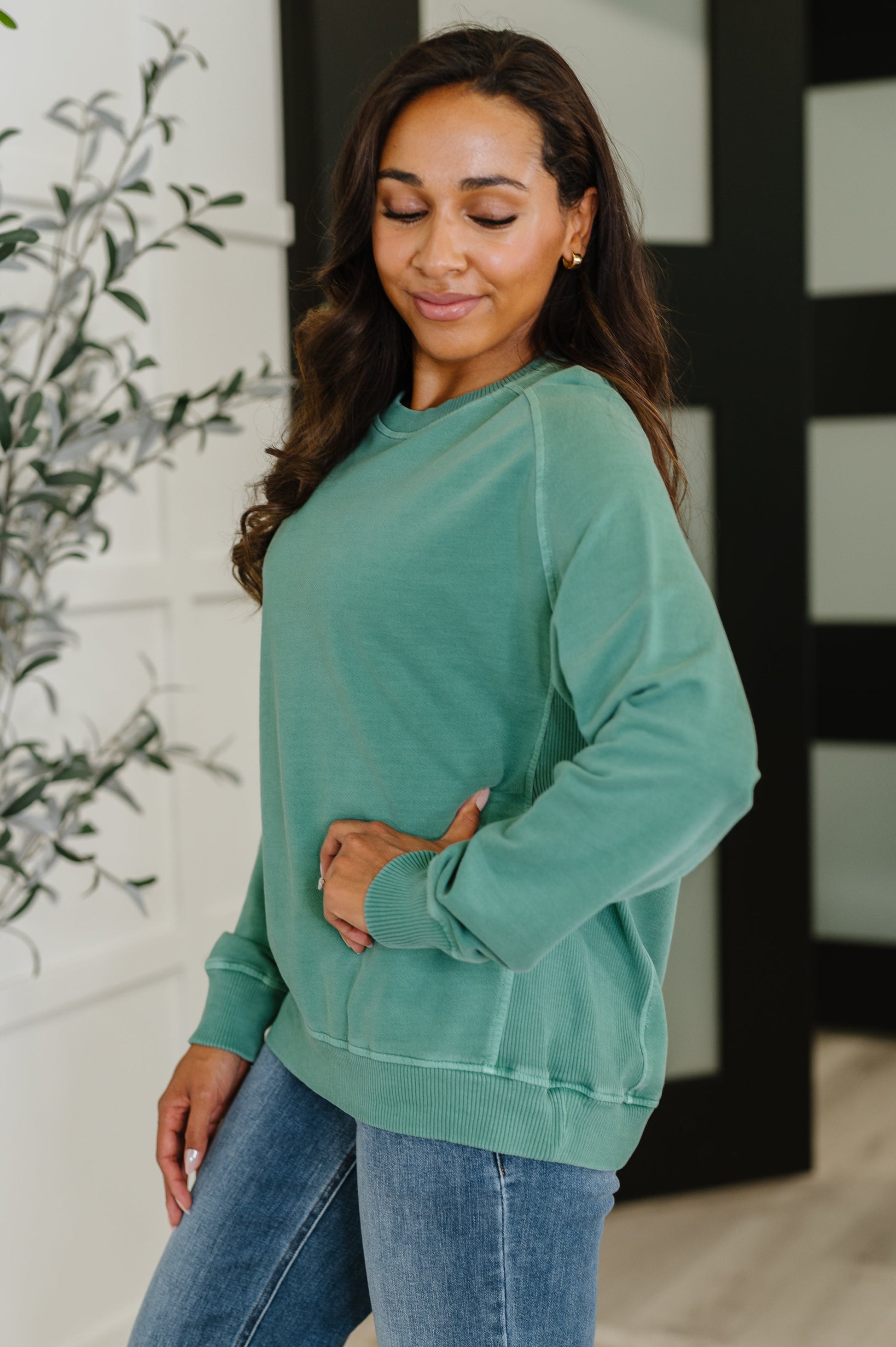 Side profile of Nicia Dark Green Mineral Wash Pullover with ribbed cuff sleeve