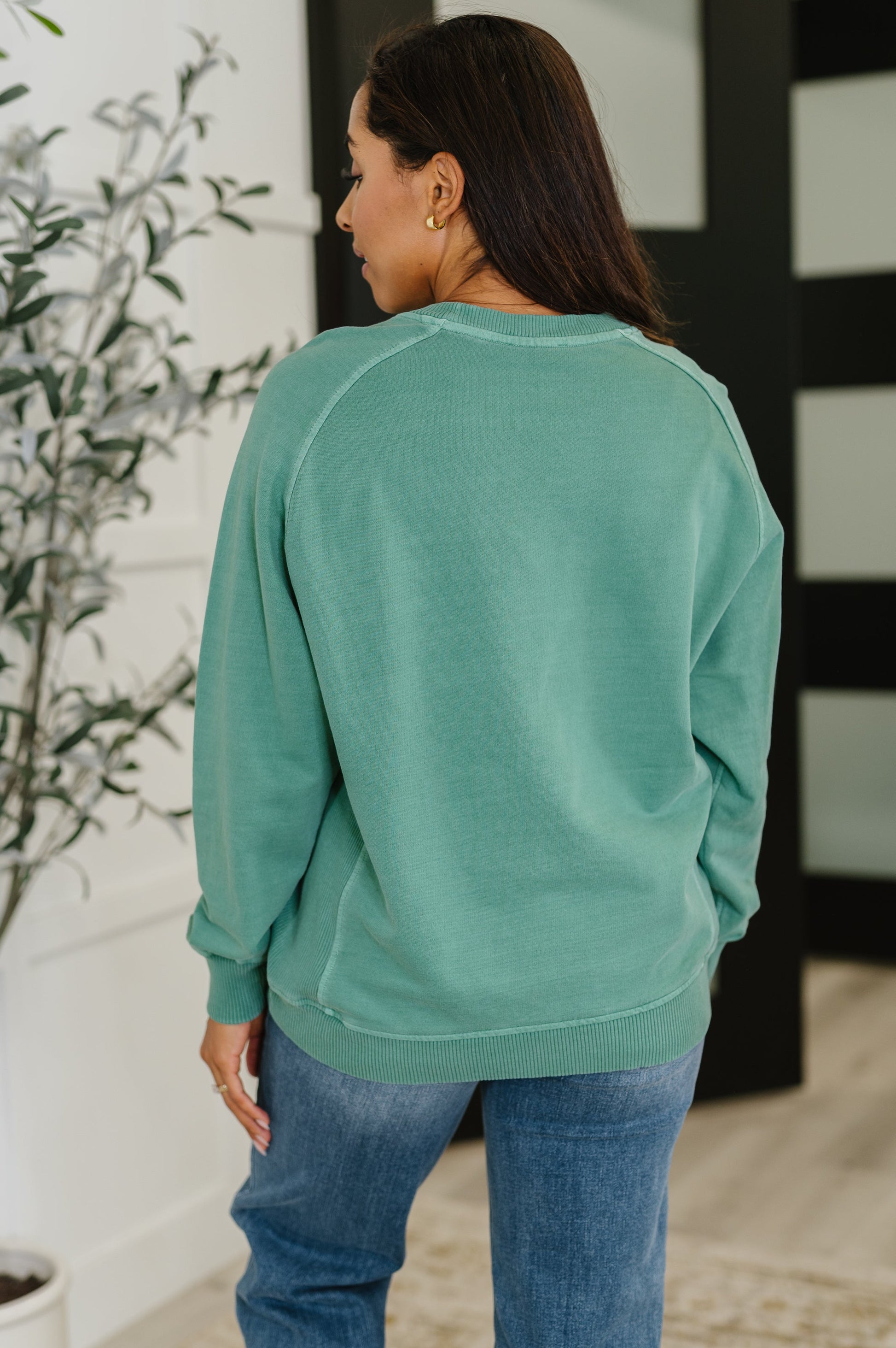 Back of Nicia Dark Green Mineral Wash Pullover showing relaxed fit and contrast detail