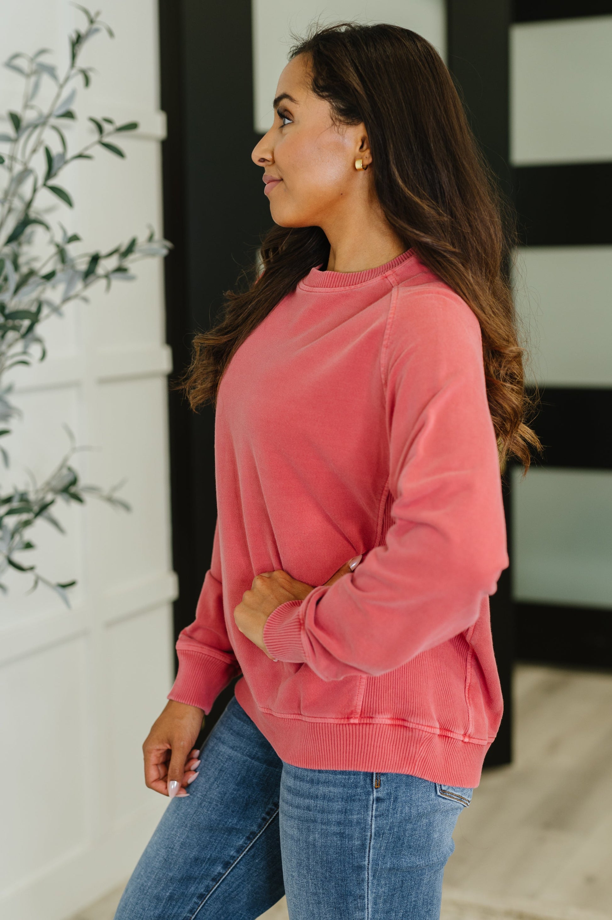 Side profile of Nicia Ruby Mineral Wash Pullover, relaxed silhouette with ribbed cuff
