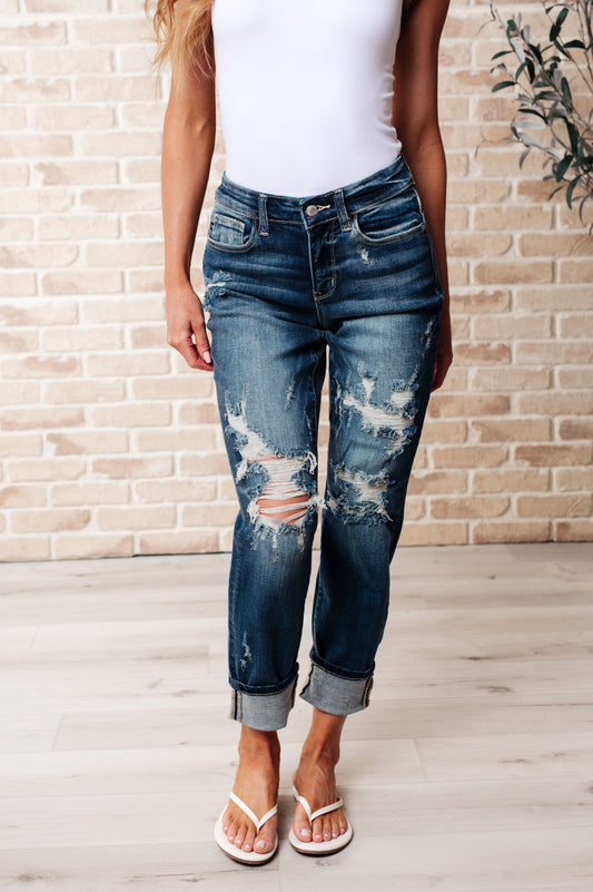 Front view of Danny mid rise boyfriend jeans in dark wash with heavy distressing, cuffed hem, and relaxed fit.