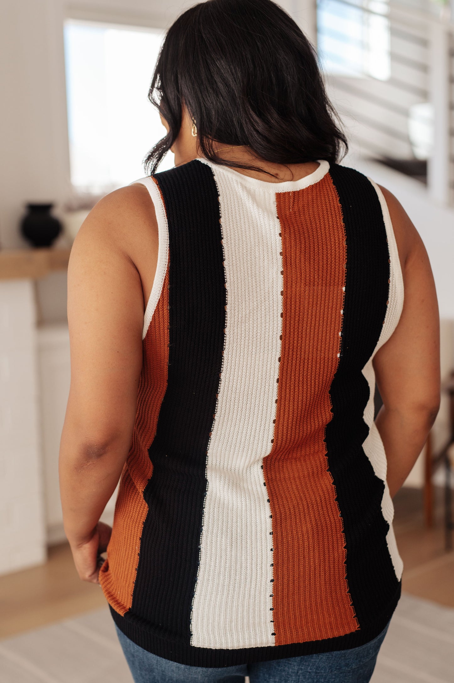 Women's Knit Striped Tank featuring vertical stripes in ivory, camel, and black with a scoop neckline and fitted silhouette.