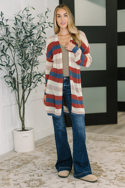Model layering Carly Striped Knit Cardigan over a neutral top for casual fall outfit.
