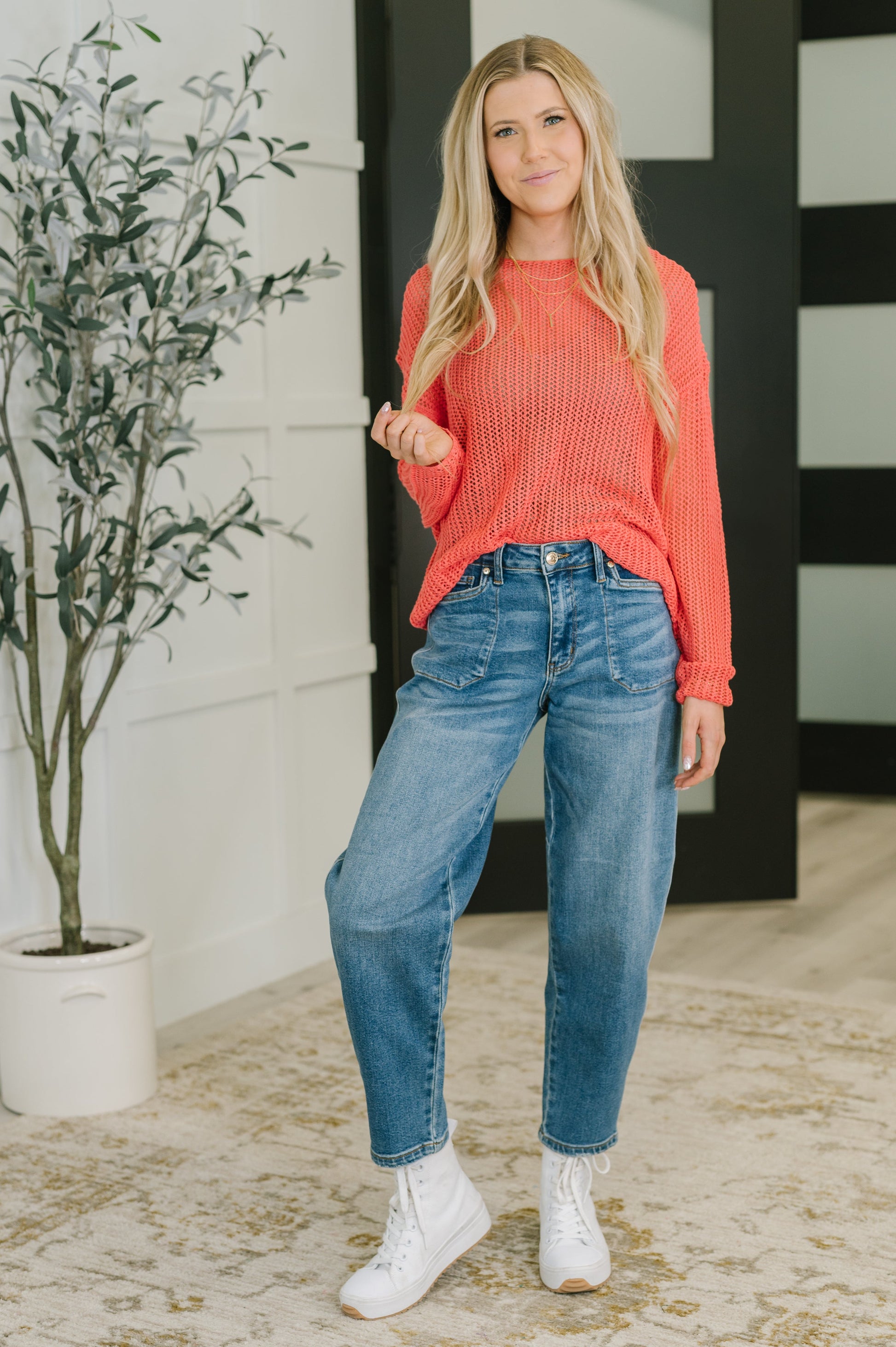 Full body view of model wearing Chaya Loose Knit Sweater with jeans and sneakers