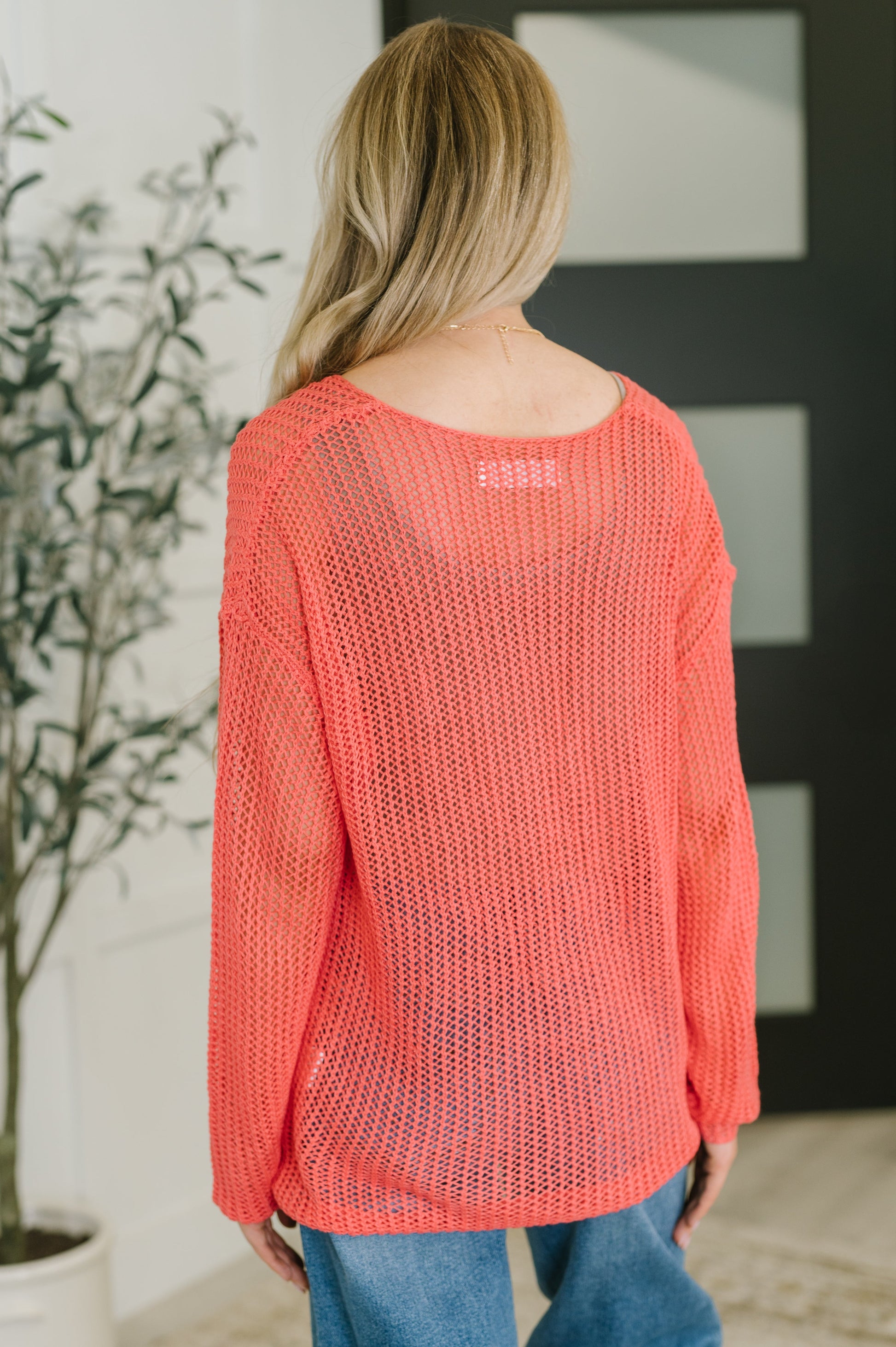 Back view of Chaya Loose Knit Sweater with open net knit design