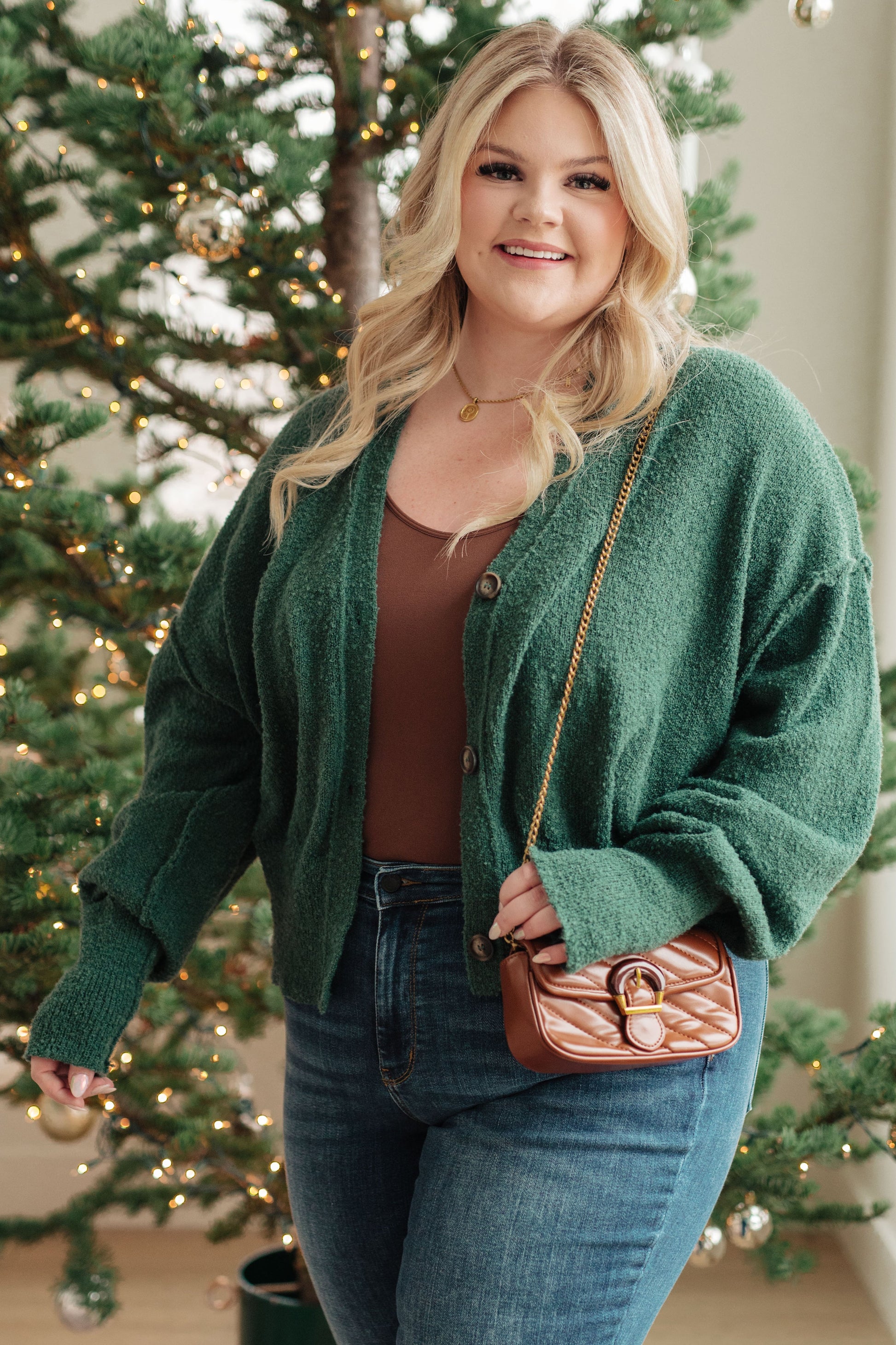 Plus size model wearing the Dido Cardigan in Green with v-neckline and bishop sleeves.