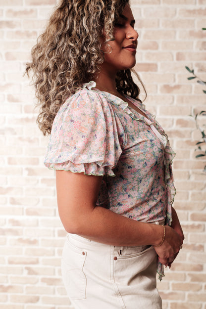 Plus size floral mesh bodysuit side angle with flattering fit and ruffle sleeve detail.