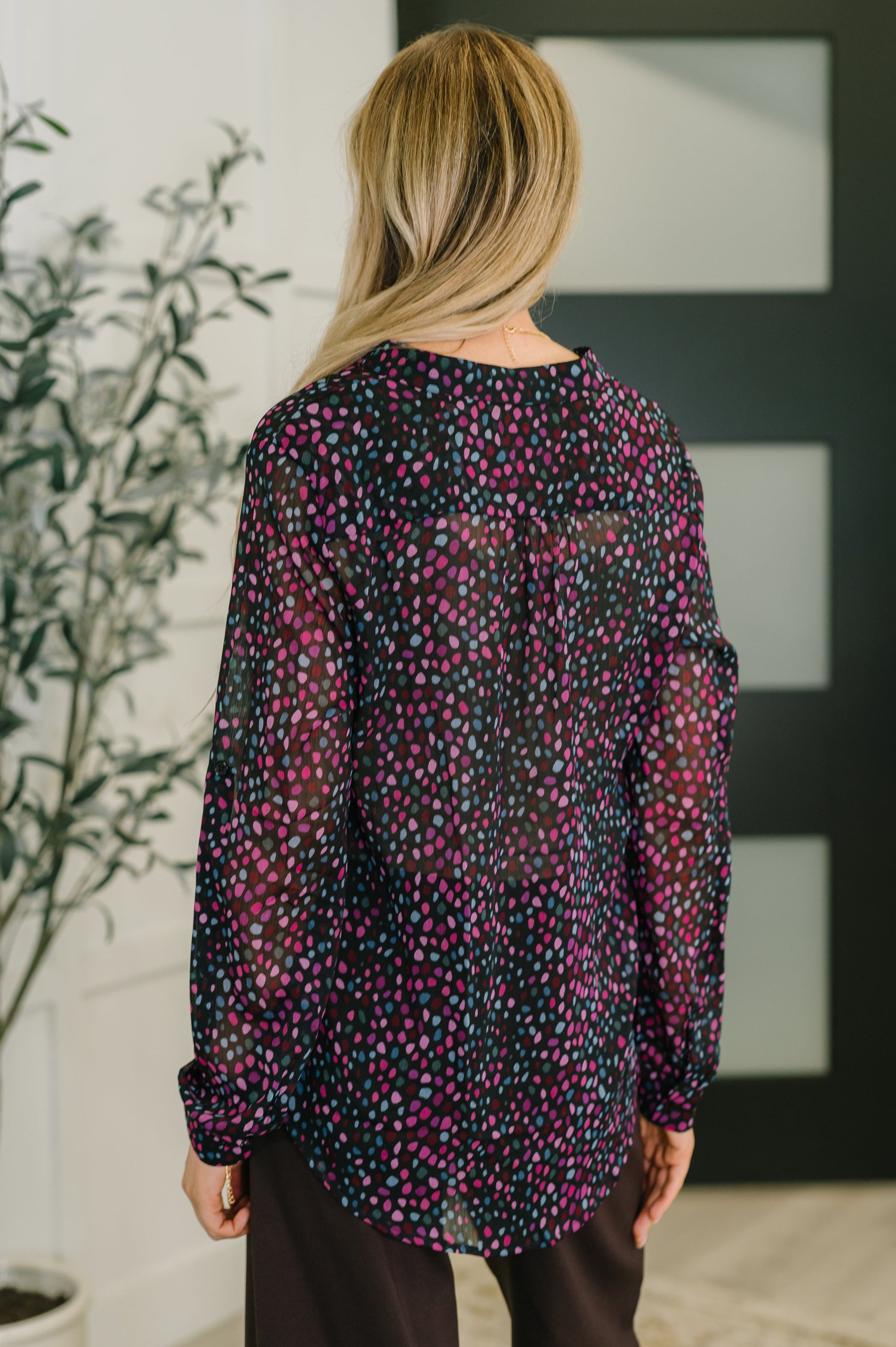 Back view of Miranda Polka Dot Blouse in black chiffon with pink and blue dots.