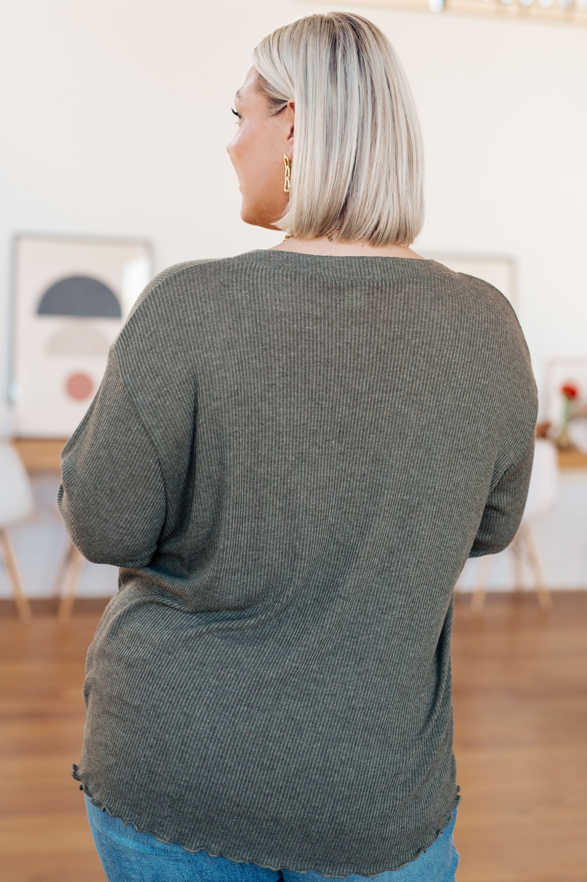 Sage gray ribbed knit top featuring a flirty front slit with tie detail, playful lettuce hem, and a flattering "Gabby" V-neckline, perfect for casual or chic outfits.