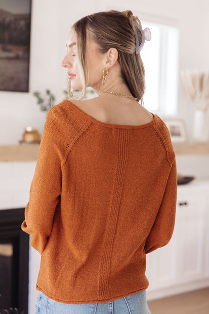 Back view of rust Dorothy Pullover Sweater showing exposed seam details and round neckline.